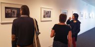 people looking at exhibition