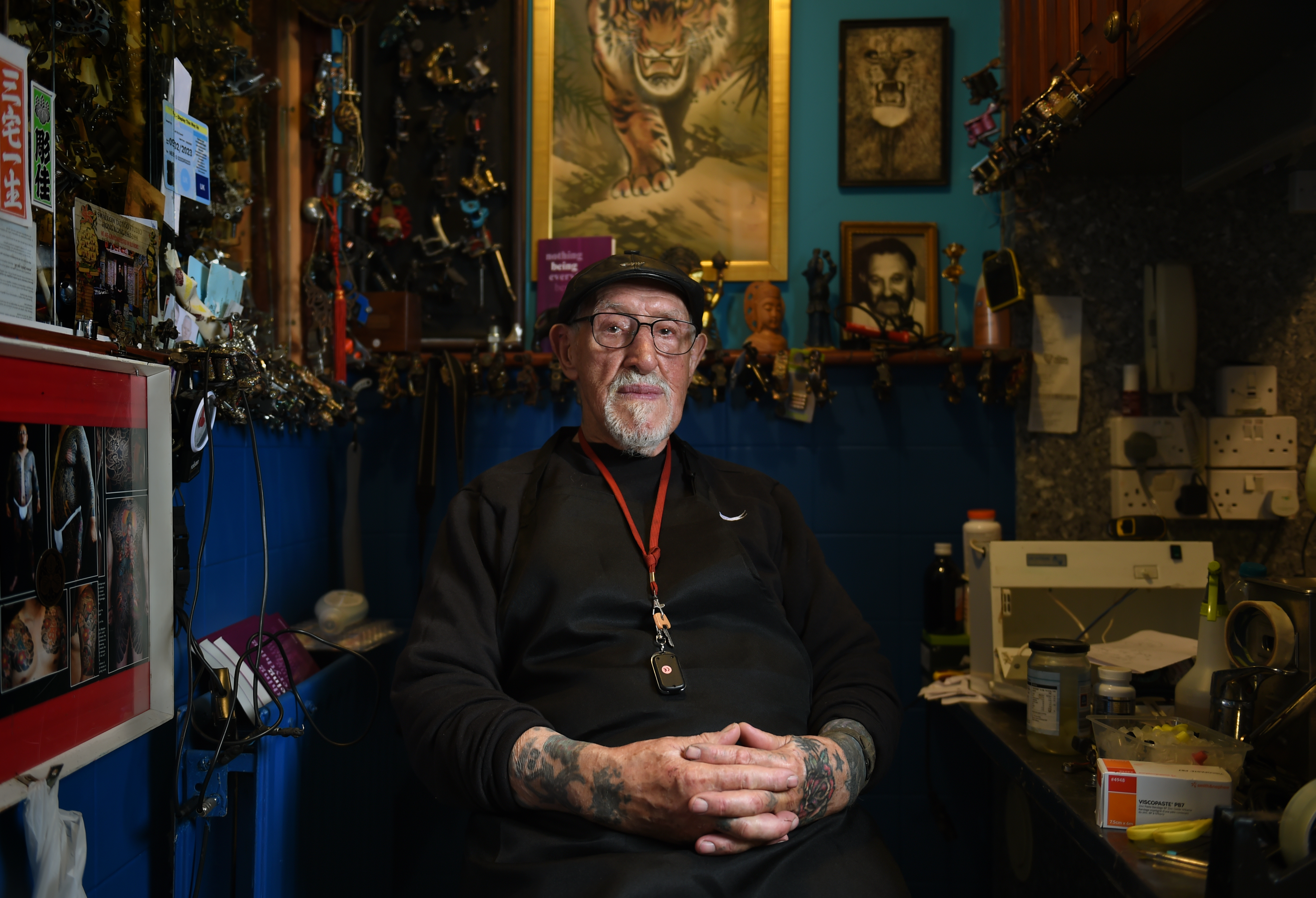 A man sat in a tattoo studio