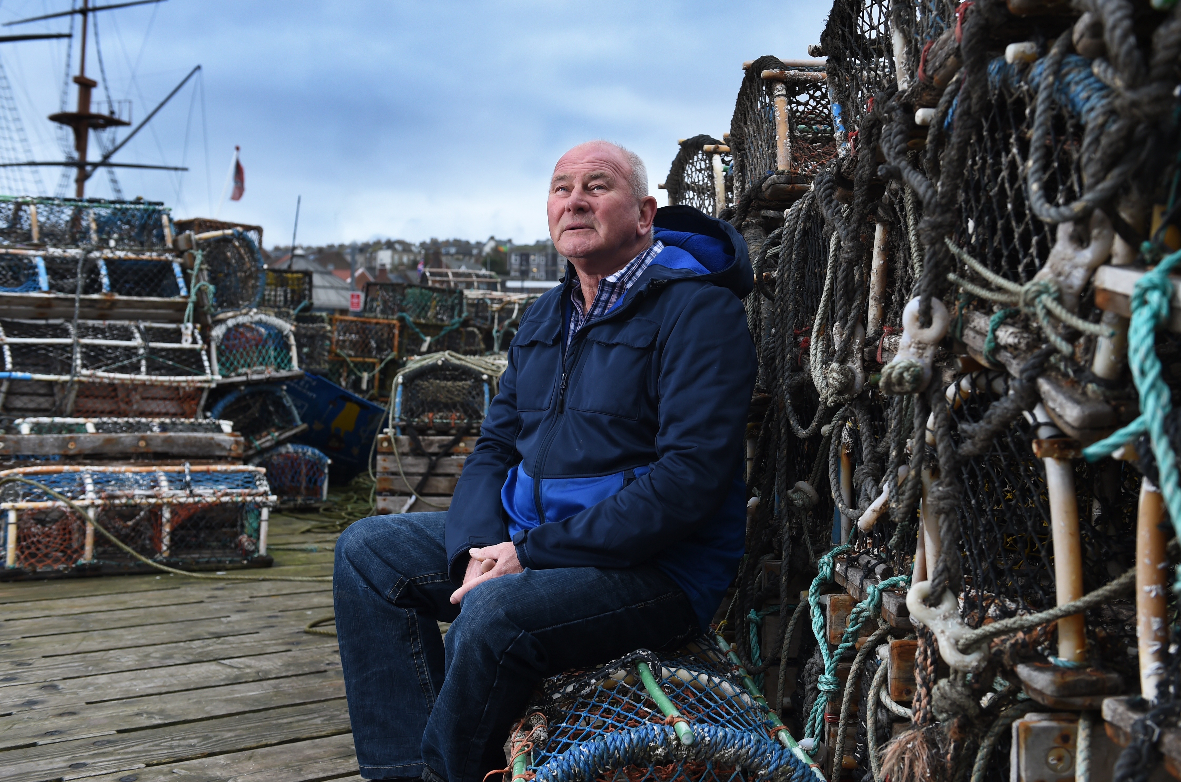A man sat next to fishing nets