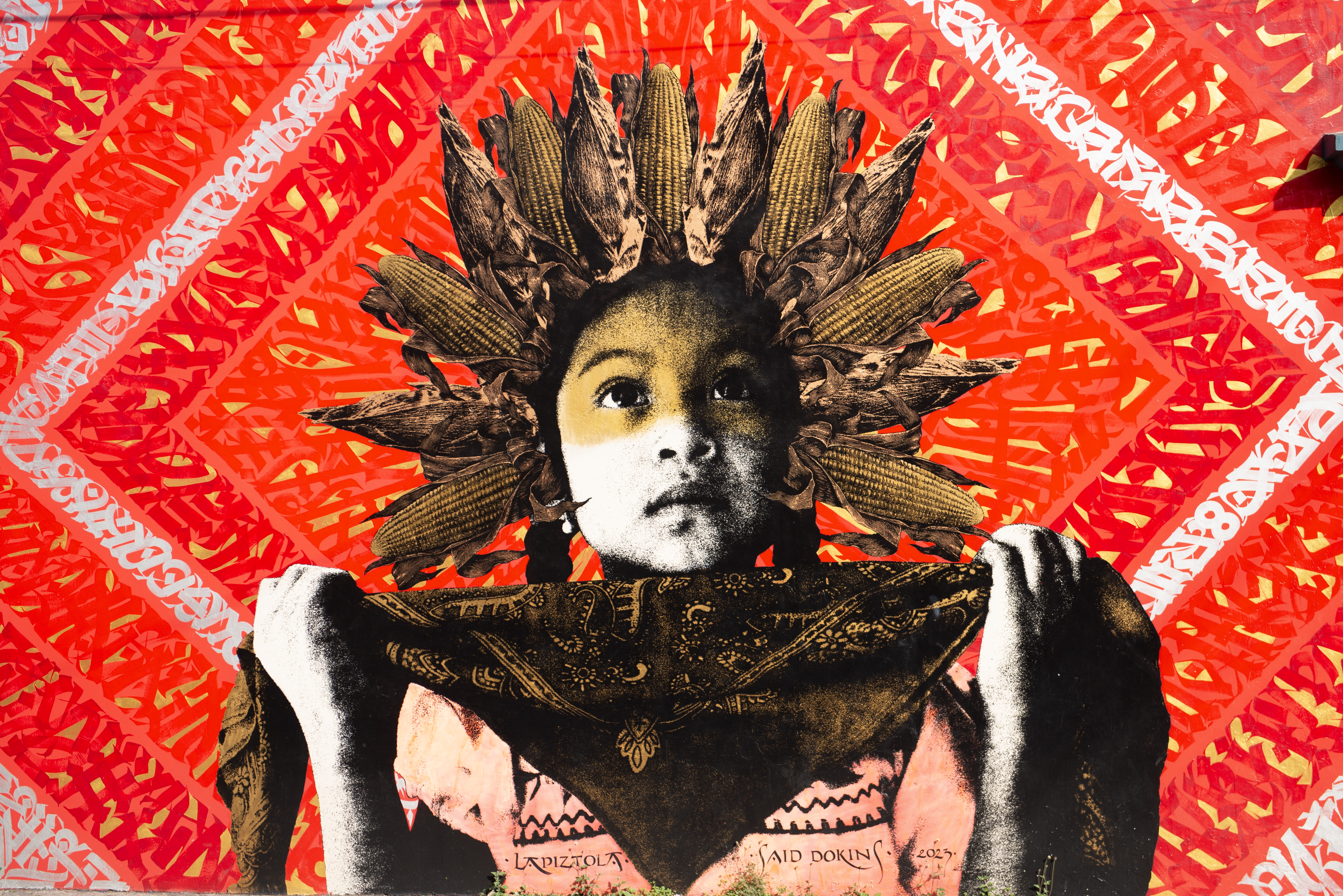 street art of young boy holding a bandana and lookin upwards hopefully